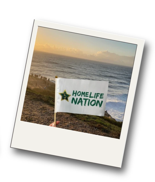 A HomeLife Nation flag overlooking the water