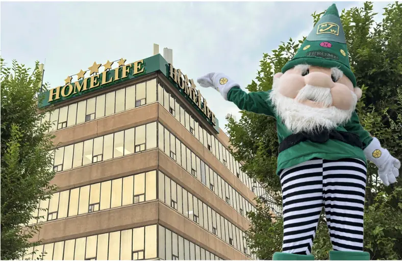 Jerome the Gnome waving in front of the HomeLife head office