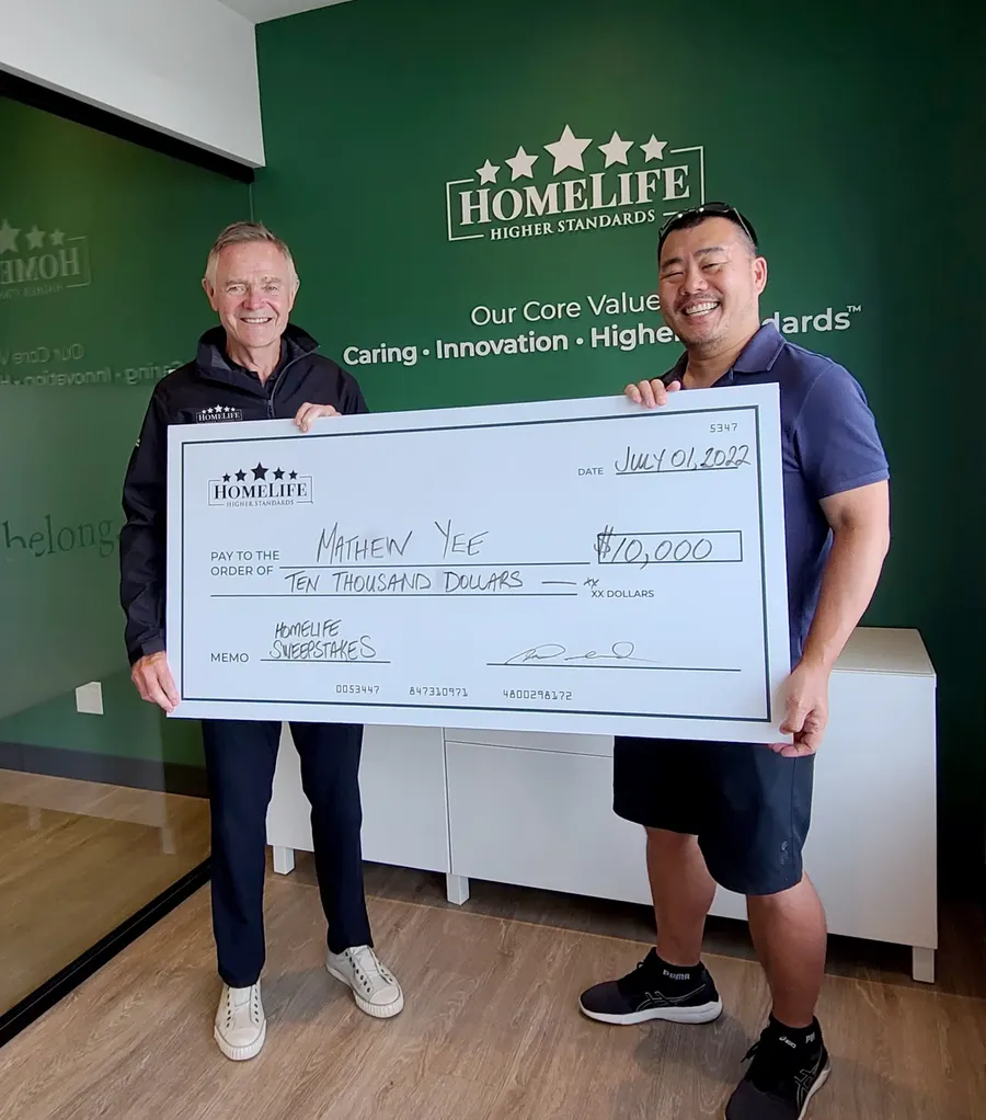 Mathew Yee receiving his $10,000 HomeLife sweepstakes cheque from Rick Dubord